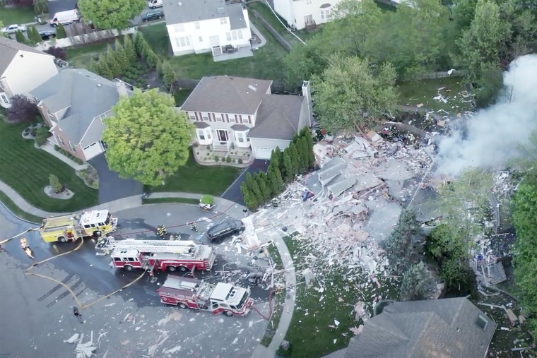 aerial firefighter trucks house explosion aftermath new jersey smoke debris destruction