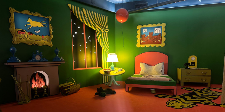 A dimly lit cartoon-like bedroom with a fireplace, bed, window, tiger rug, and balloon on the ceiling