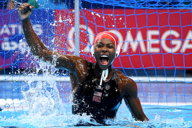 Ashleigh Johnson celebrates in the water.