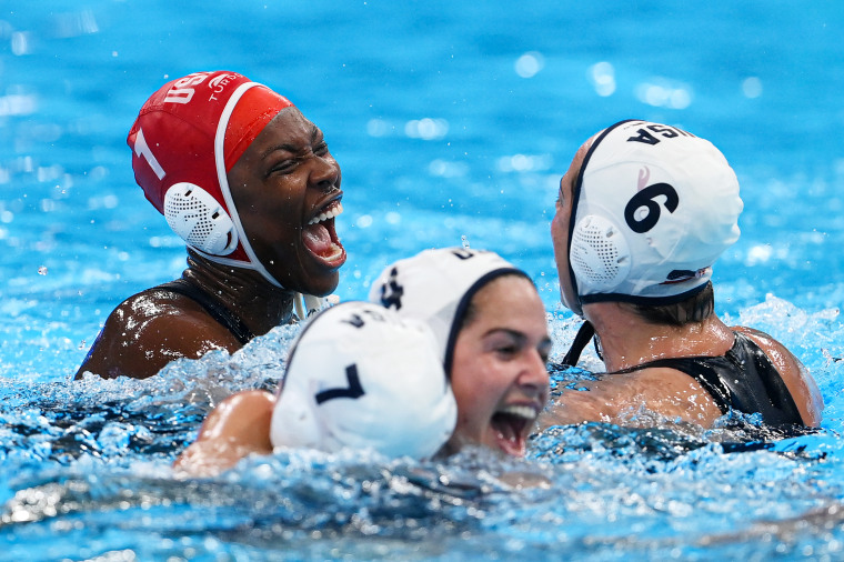 Ashleigh Johnson and her team celebrate in the water.