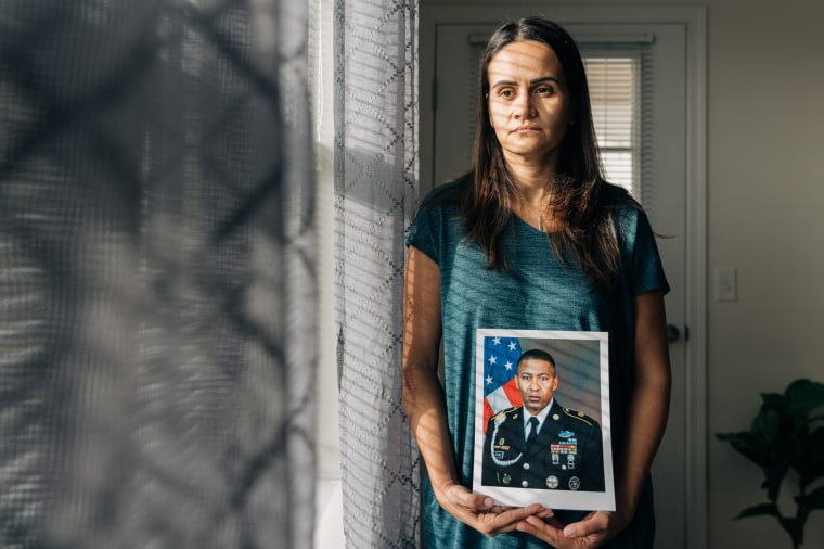 Natasha Cruz-Bevard holds a photo of her husband Rodney C. Bevard.