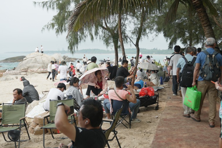 Spectators on a beach near the Wenchang Space Launch Site on Thursday.