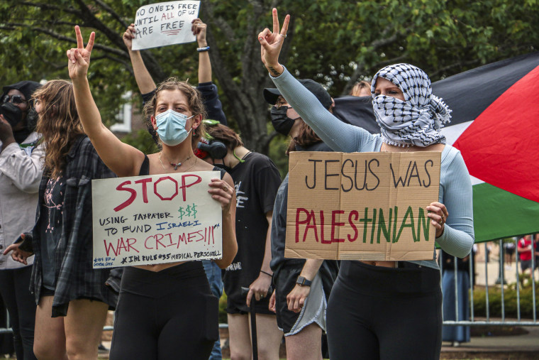 Pro-Palestinian demonstrators hold signs protesting the Israel-Hamas war Thursday, May 2, 2024, at the University of Mississippi.