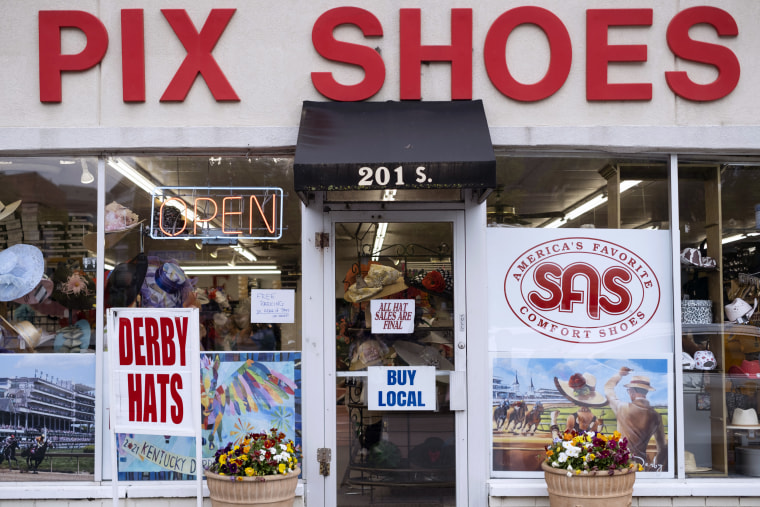 The exterior of Pix Shoes in Louisville with signs advertising Derby Hats.