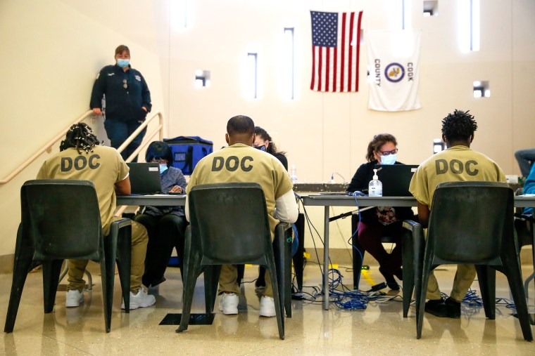 Three detainees seated at a table