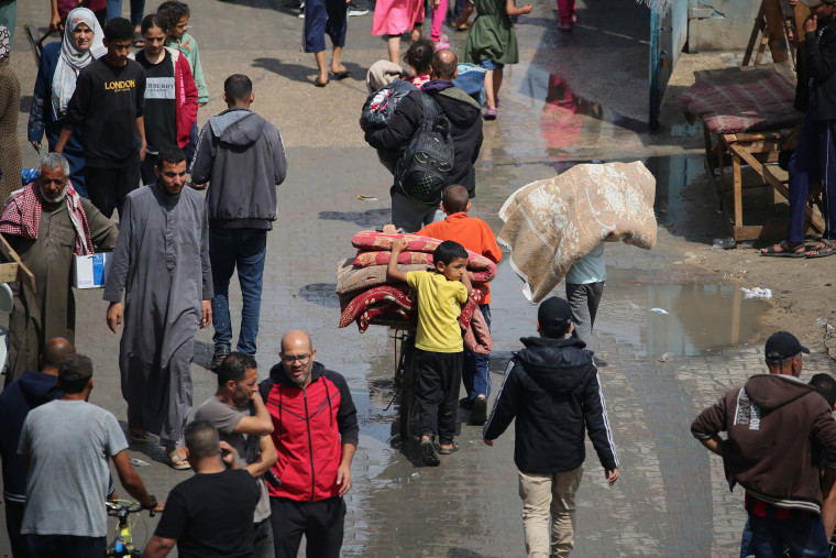 Displaced Palestinians flee Rafah as Israel orders evacuation. 
