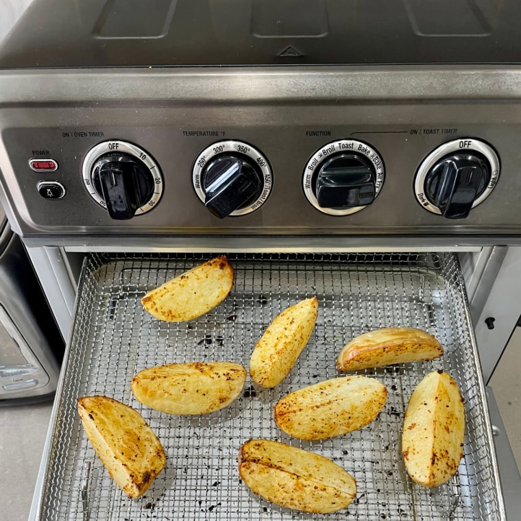 Diced potatoes roasted on the basket tray in the Cuisinart air fryer.