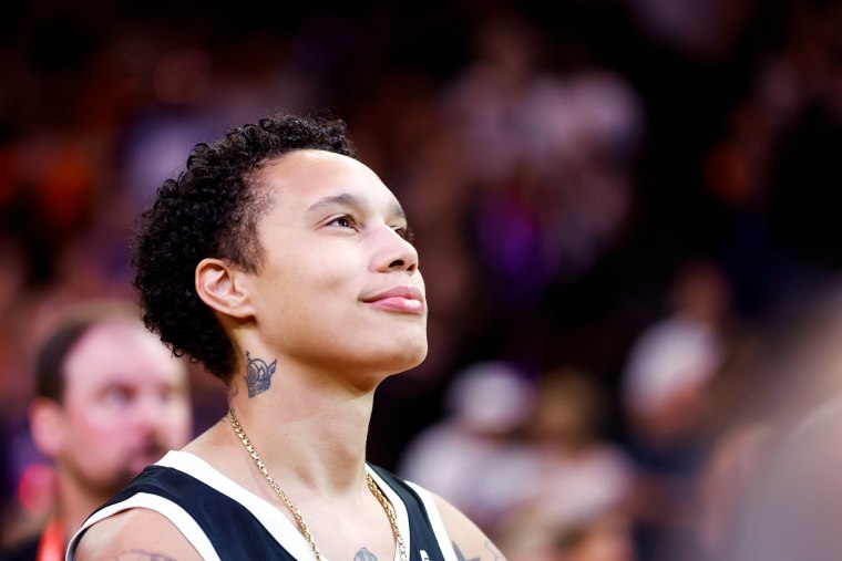 Brittney Griner smiles while looking up on the basketball court