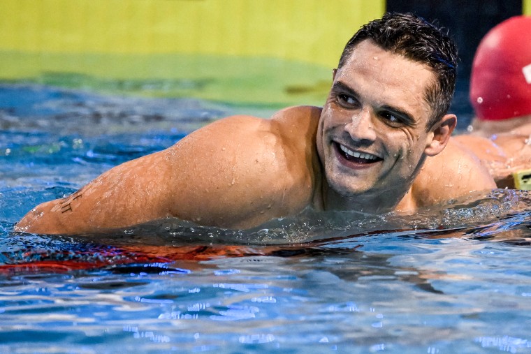 Florent Manaudou smiles while swimming in a pool