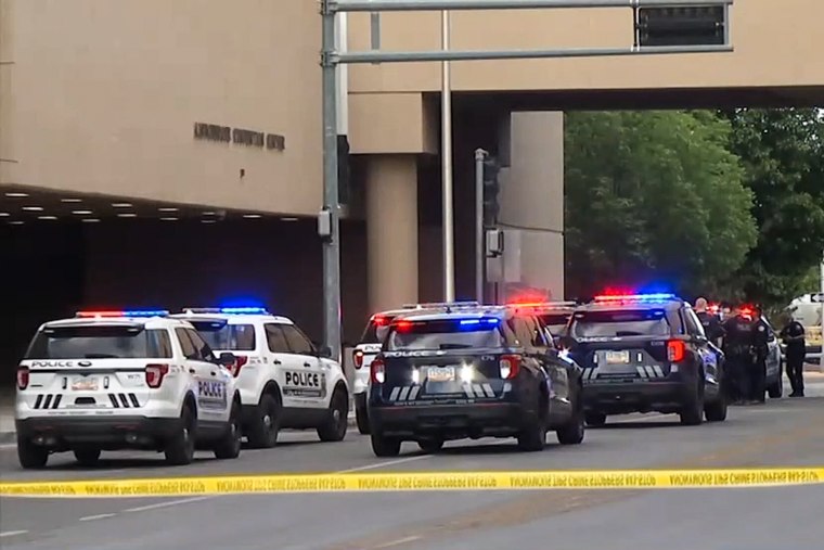 Police cars and police tape surround the Albuquerque Convention Center