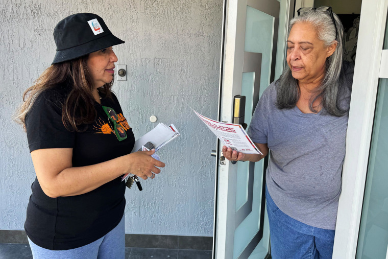 Gina Romero speaks with Doris Saldá while she canvasses