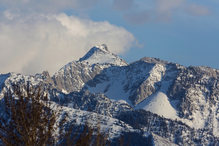 Clouds over snowy Lone Peak in the Wasatch Mountain Range by Salt Lake City, Utah.