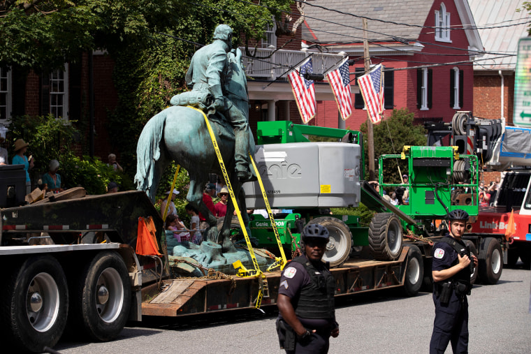  Jackson's statue is placed on a truck as officers stand guard