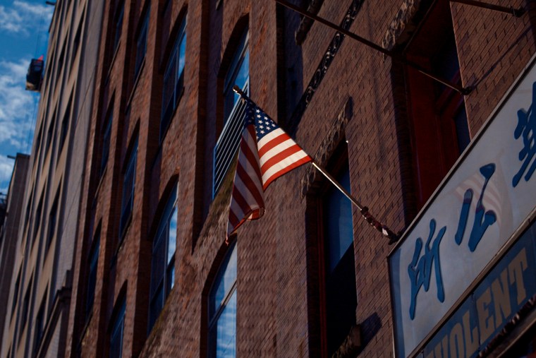 A building in Chinatown with a U.S. flag.