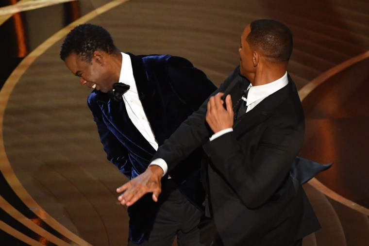 Will Smith, right, slaps Chris Rock onstage during the Oscars 