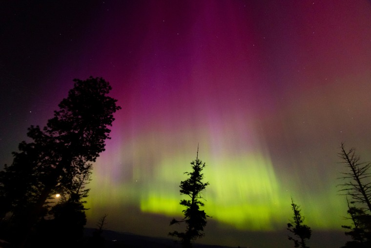 Northern lights in the sky, magenta and green