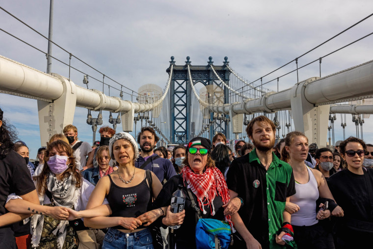 Pro-Palestinian demonstrators join arms as they block traffic on the Manhattan Bridge.