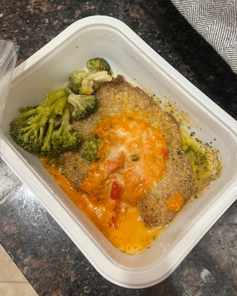 Chicken and broccoli meal on a plastic tray.