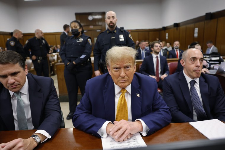 Former President Donald Trump sits in the courtroom with his attorneys