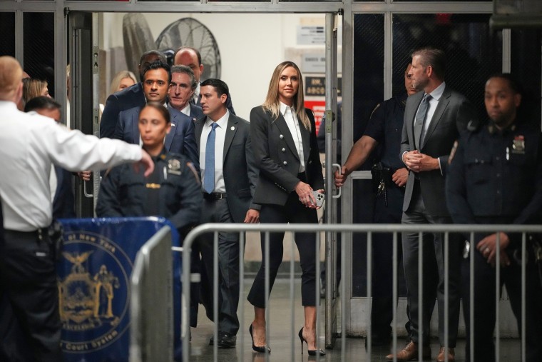 Lara Trump, center, and Eric Trump arrive at Manhattan Criminal Court on May 14, 2024.