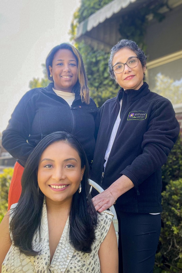 Milagros Aquino, seated, with community health worker Massiel Olivo, left. and Jacqueline Carrizo, a doula who was assigned to her by the Emme Coalition.