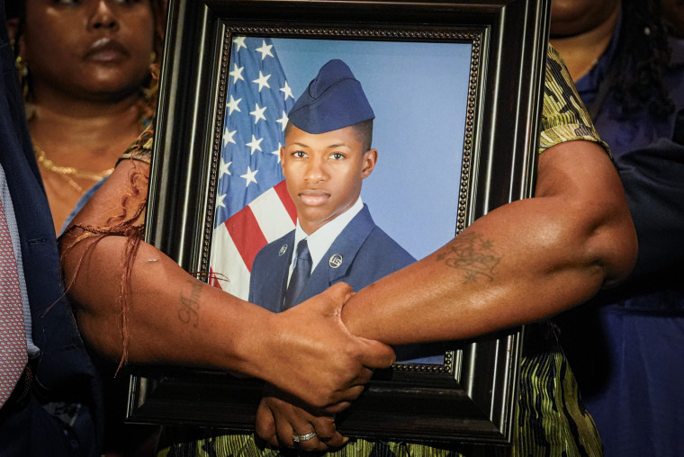 Chantemekki Fortson, mother of Roger Fortson, holds a photo of her son during a news conference.