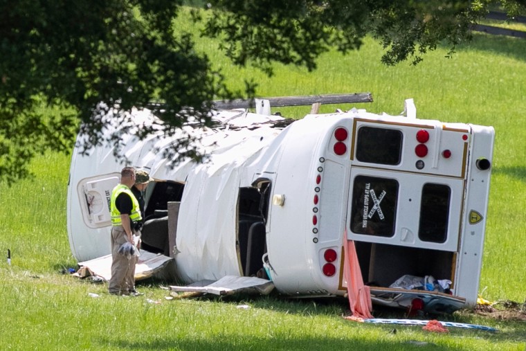 Authorities work at the scene of a deadly crash