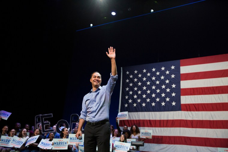 Julián Castro smiles and waves