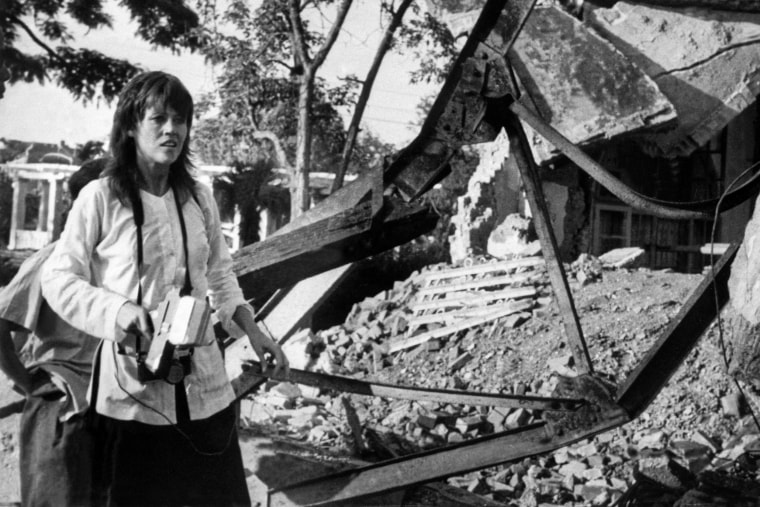 Jane Fonda, holding a camera, in Vietnam.