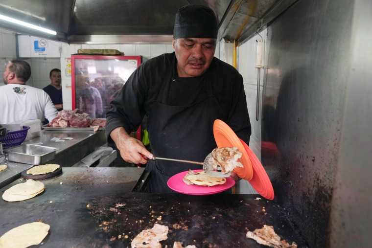 Arturo Rivera Martínez prepares an order of tacos 
