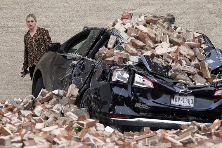 A woman looks at the damage caused by fallen bricks in the aftermath of a severe thunderstorm Friday, May 17, 2024, in Houston. Image: