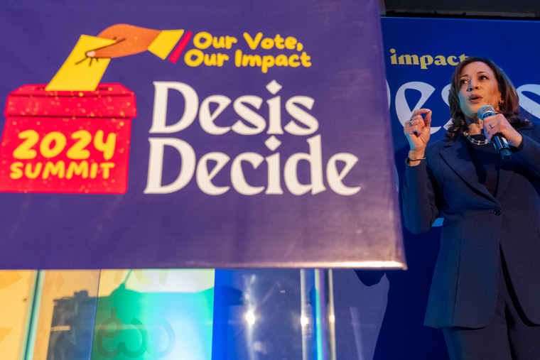 Kamala Harris speaks  next to a sign that reads "2024 Summit Our Vote, Our Impact Desis Decide"