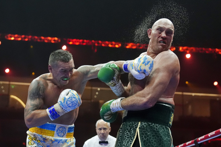 Britain’s Tyson Fury, right, takes a blow from Ukraine’s Oleksandr Usyk