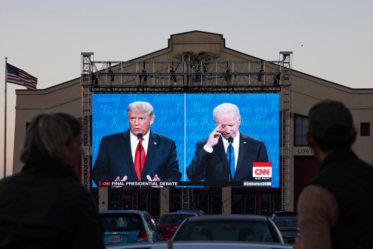People watch the debate on a large outdoor screen