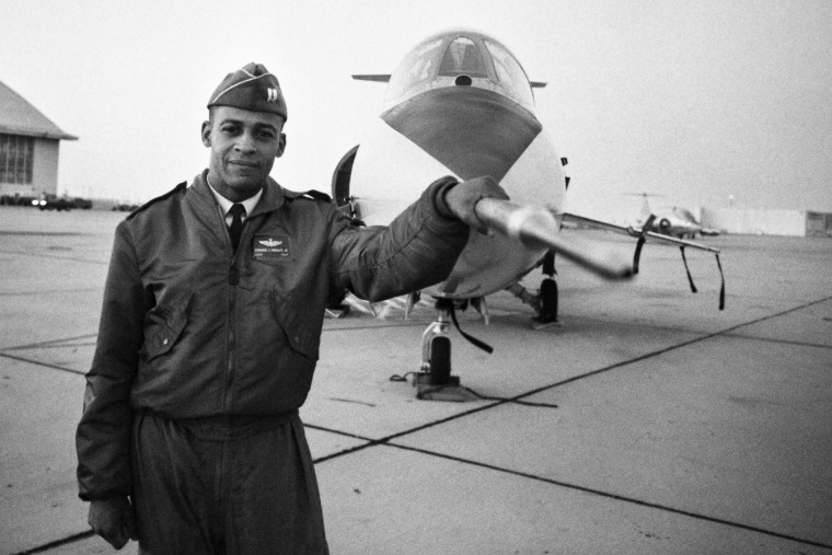 Captain Ed Dwight poses in front of a F-104 fighter jet in 1963.