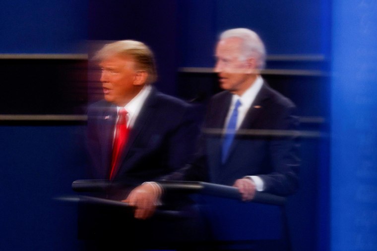 Then-President Donald Trump and then-Democratic presidential nominee Joe Biden are reflected in  plexiglass during their debate in Nashville on Oct. 22, 2020. 