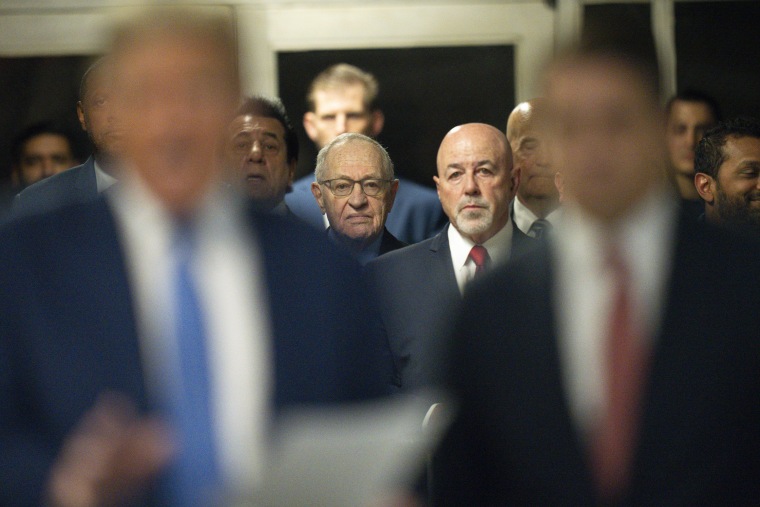 Alan Dershowitz and Bernard Kerik listen as former President Donald Trump speaks to reporters