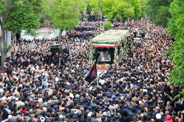 People participate in a funeral procession alongside a lorry carrying the coffins of president Ebrahim Raisi and his seven aides in Tabriz, East Azerbaijan province, on May 21, 2024.
