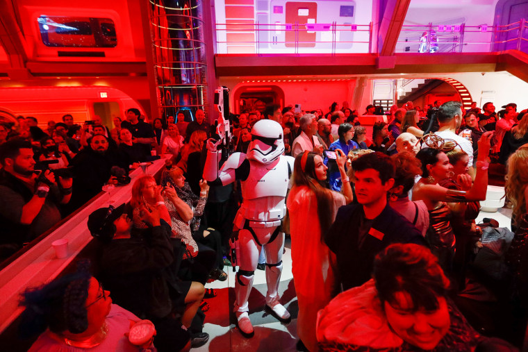A First Order Stormtrooper patrols through the crowd