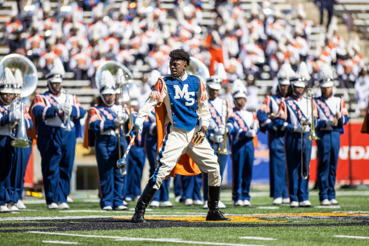 The Morgan State University marching band performs on the field in blue and white costumes