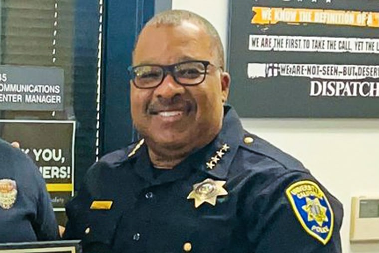 John Thomas smiles in his police uniform