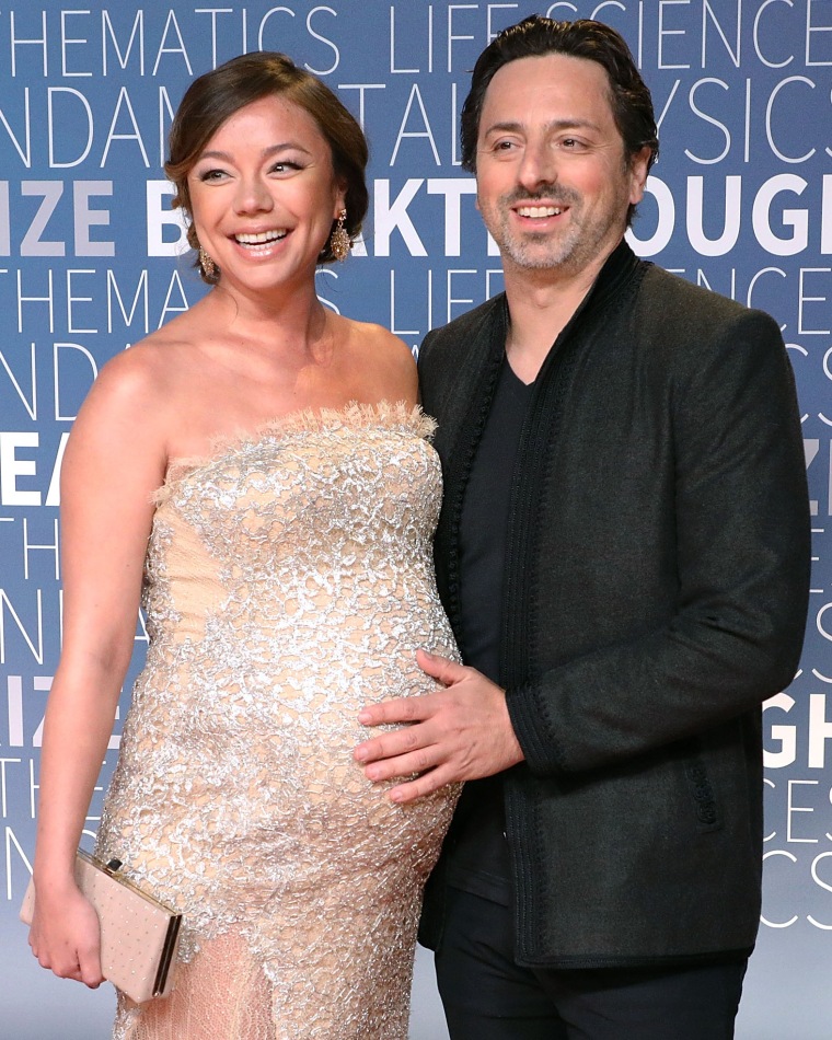Sergey Brin puts his hand on Nicole Shanahan's belly during her pregnancy.