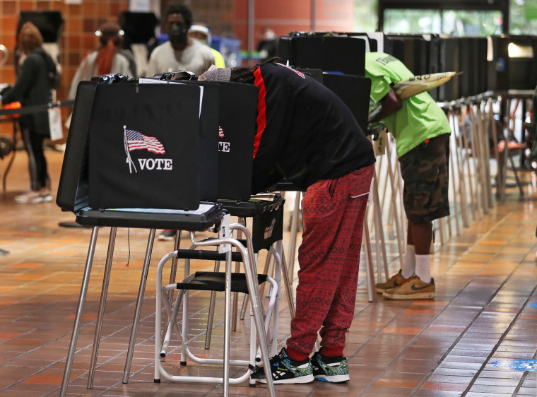 Voters fill out their ballots as they vote