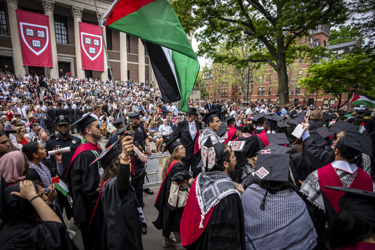 Image: Graduating Harvard students walk out in protest over the 13 students who have been barred from graduating