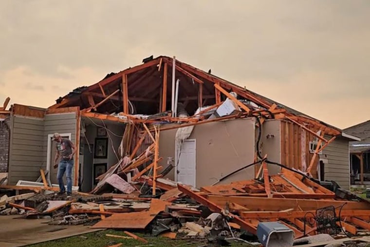 A resident assesses the damage after a tornado struck Temple, Texas.