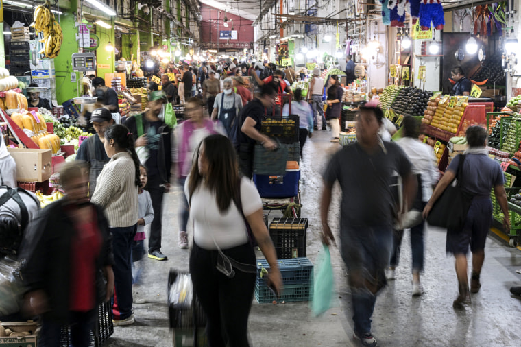 People walk inside the main market.