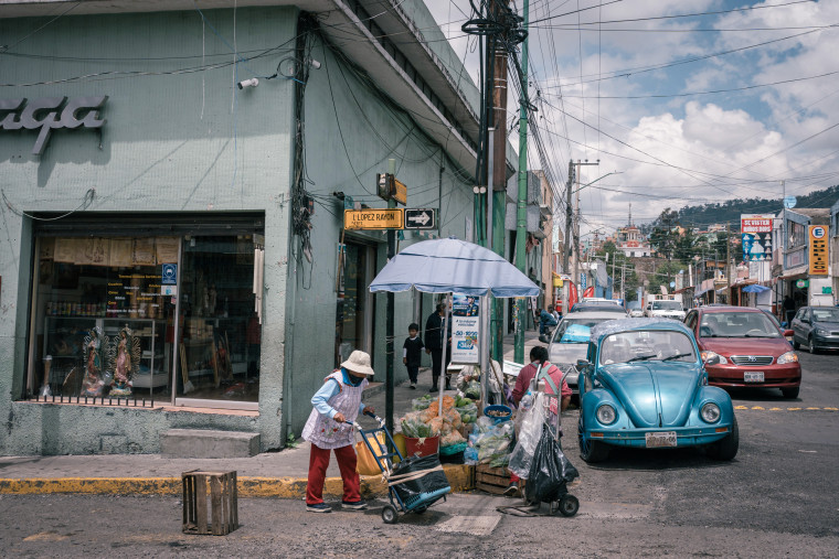 Shoppers near a market .