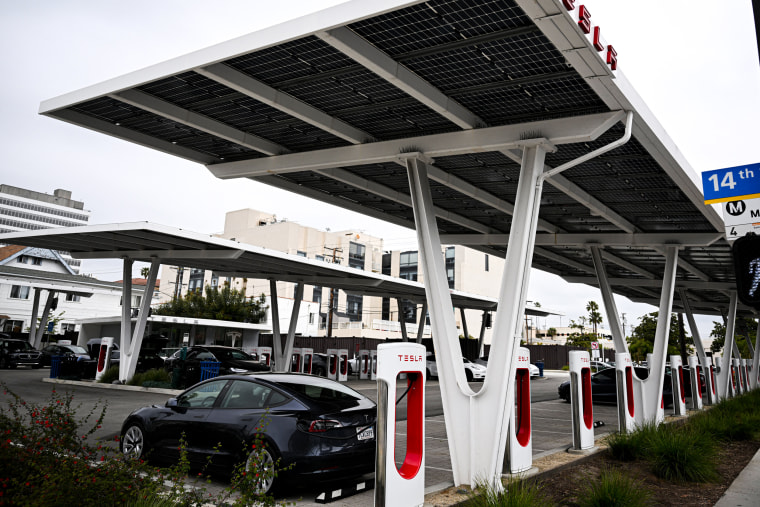 Tesla electric vehicles charge on EV charging stations.