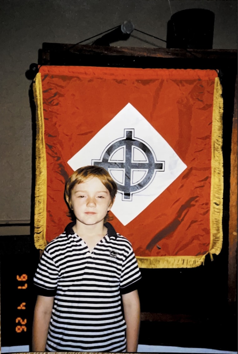 Derek at age 8 with a white nationalist flag