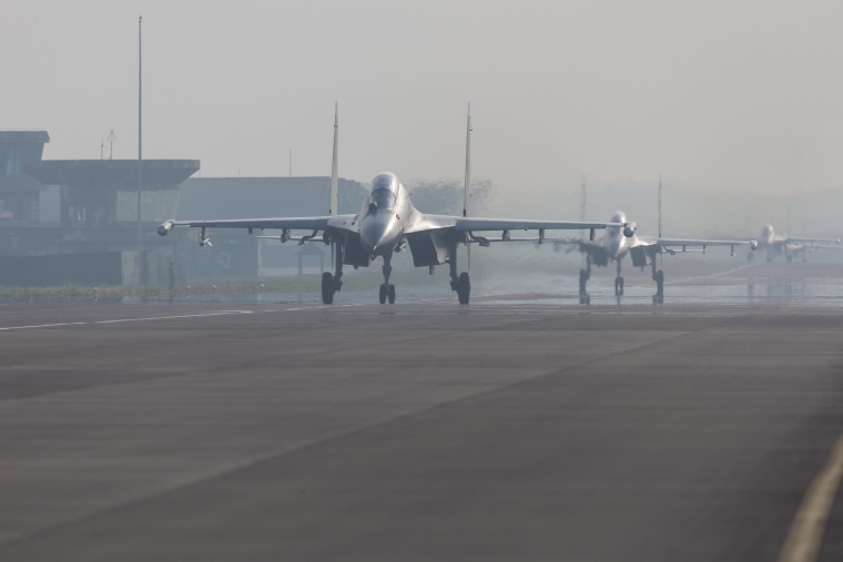 Chinese fighter jets preparing to take off during the "Joint Sword-2024A" military drill at an unknown location.